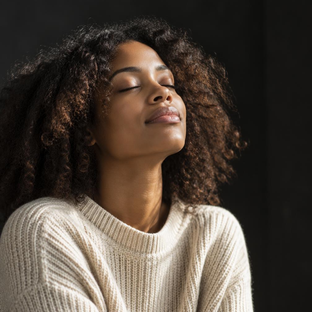 A woman breathing deeply in soft natural light